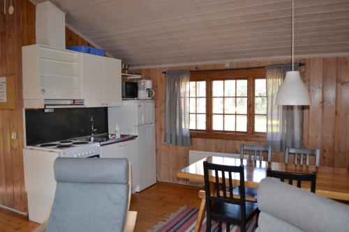 a kitchen and dining room with a table and chairs at First Camp Enåbadet - Rättvik in Rättvik