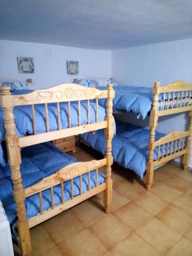 a bedroom with two bunk beds with blue sheets at Apartamento Valdelinares,Casa la roca in Valdelinares