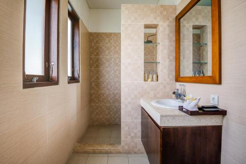 a bathroom with a sink and a mirror at Villa Raka Managed by Manara in Legian