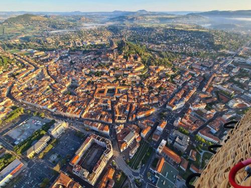 an aerial view of a city with buildings at ibis budget Le Puy En Velay in Le Puy en Velay