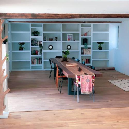 a dining room with a long table and shelves at Little Farm Comfort&PrestigeHouse in Ittre