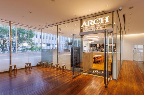 a store with chairs and a table in a building at remm Hibiya in Tokyo