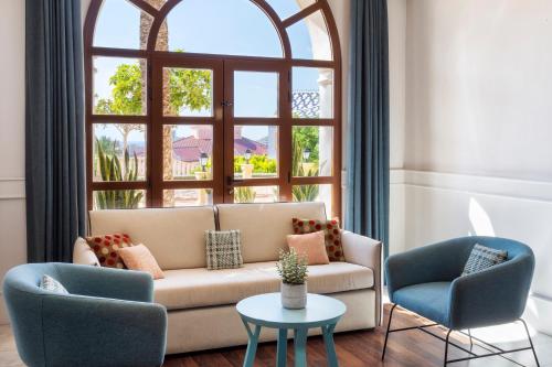a living room with a couch and two chairs and a window at Melia Villaitana in Benidorm