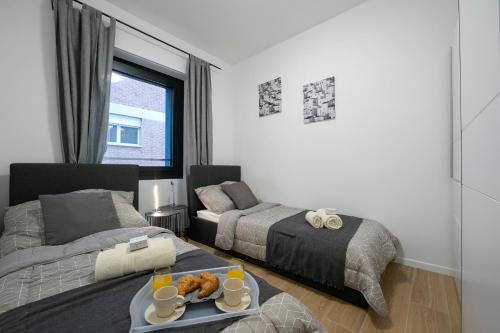 Postel nebo postele na pokoji v ubytování Boutique Apartments