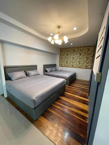 a bedroom with two beds and a ceiling at My home resort - ขนอม นครศรีธรรมราช in Khanom