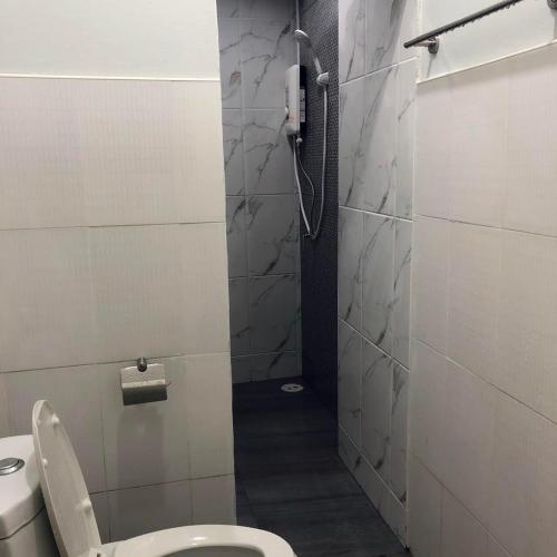 a bathroom with a shower with a toilet and a phone at My home resort - ขนอม นครศรีธรรมราช in Khanom