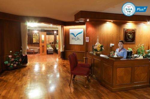 a woman sitting at a reception desk in a salon at Duangtawan Hotel Chiang Mai in Chiang Mai