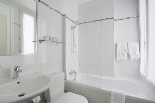 a white bathroom with a toilet and a sink at Hotel Gabriel Issy Paris in Issy-les-Moulineaux