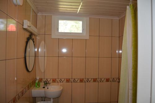 a bathroom with a sink and a toilet and a window at Svinö Seaside Villa in Lumparland
