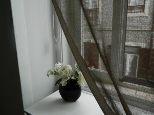 a vase with flowers sitting on a window sill at Enjoy Mouraria Apartments in Lisbon