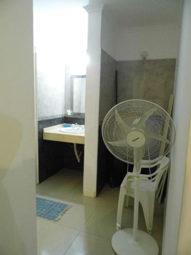 a bathroom with a white fan and a sink at Ayres de Las Sierras in Villa Carlos Paz