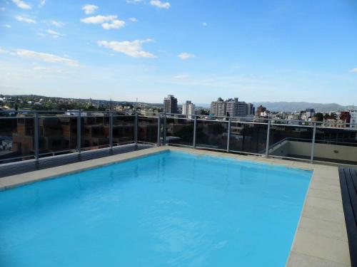 a swimming pool on the roof of a building at Ayres de Las Sierras in Villa Carlos Paz