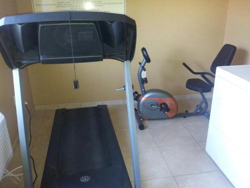 a room with a treadmill and two exercise bikes at Cobblestone Inn & Suites - Hartington in Hartington