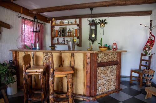 a bar in a room with wooden tables and chairs at Apartment Resman Tršće in Tršće