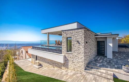 a stone house with a deck with a view at Villa Nina in Šmrika