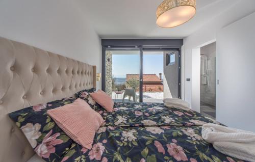 a bedroom with a bed with a floral bedspread at Villa Nina in Šmrika