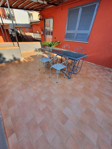 a ping pong table and chairs on a patio at Bed & Breakfast Neapolis in Ercolano