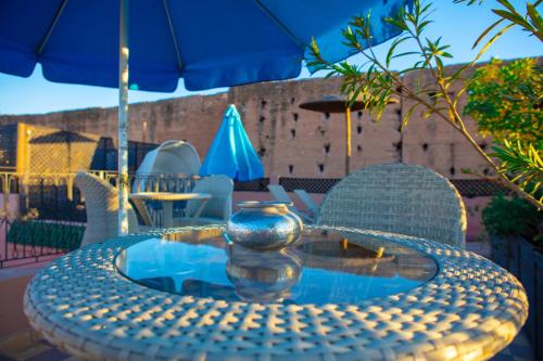 a table with a vase sitting on top of it at Riad Al Wafaa in Marrakesh