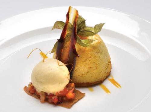 a white plate with a piece of food on a plate at Grovefield House Hotel in Slough