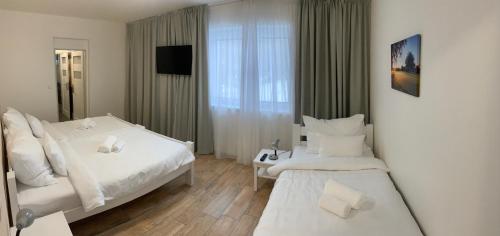 a hotel room with two beds and a window at Golf Čertovo břemeno in Jistebnice