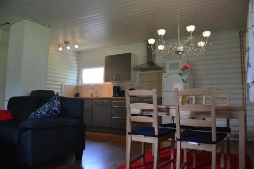 a kitchen and dining room with a table and chairs at Svinö Seaside Villa in Lumparland