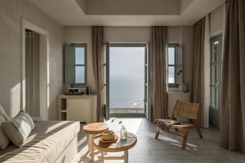 a living room with a couch and a view of the ocean at Verina Astra in Artemonas