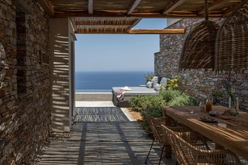 a patio with a table and a view of the ocean at Verina Astra in Artemonas
