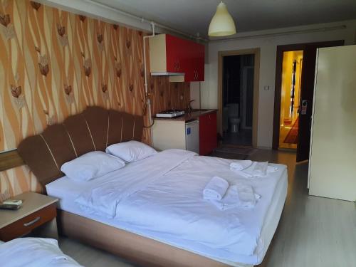 a bedroom with a bed with white sheets and pillows at Selimiye Palace in Edirne