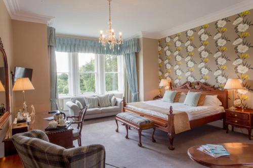 a bedroom with a bed and a living room at Grinkle Park Hotel in Loftus