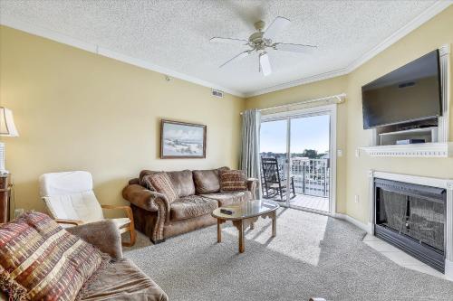a living room with a couch and a fireplace at Mariners Watch 205 in Ocean City