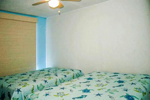 a bedroom with a bed and a ceiling fan at Polynesian in Ocean City