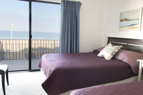 a bedroom with a bed and a view of the ocean at Ocean Hideaway in Ocean City