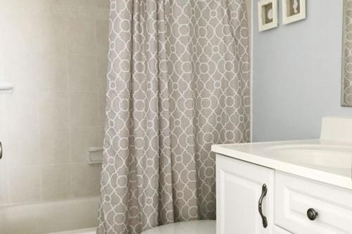 a bathroom with a shower curtain and a sink at Ocean Hideaway in Ocean City