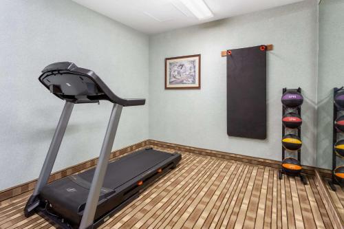 a gym with a treadmill and a chalkboard on the wall at Baymont by Wyndham Queensbury/Lake George in Queensbury