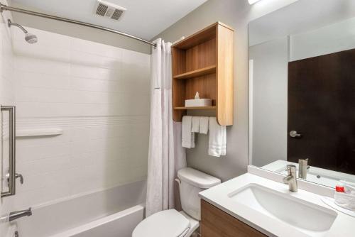 a bathroom with a white toilet and a sink at Microtel Inn & Suites by Wyndham Warsaw in Warsaw