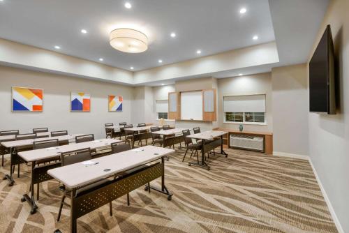 a classroom with tables and chairs and a screen at Microtel Inn & Suites by Wyndham Warsaw in Warsaw