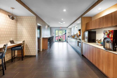 a kitchen with a long hallway with a counter and a table at Microtel Inn & Suites by Wyndham Warsaw in Warsaw