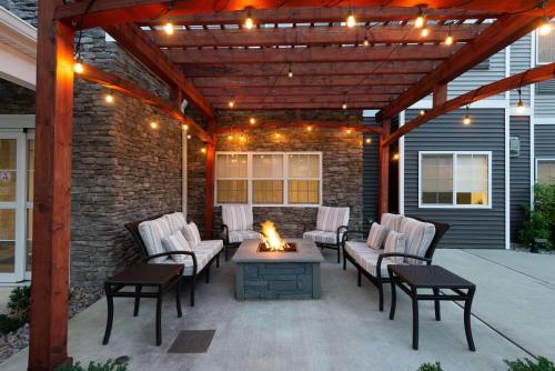 an outdoor patio with chairs and a fire pit at Microtel Inn & Suites by Wyndham Warsaw in Warsaw
