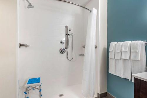 a bathroom with a shower with white towels at Sleep Inn in Georgetown