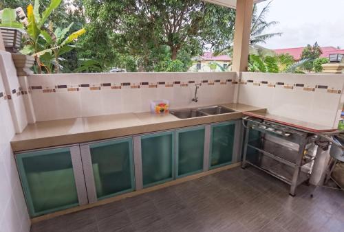 an outdoor kitchen with a sink and a counter at Happy Journey Homestay Mersing in Mersing