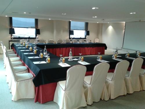 a conference room with a long table and chairs at Hotel Bahía in Santander