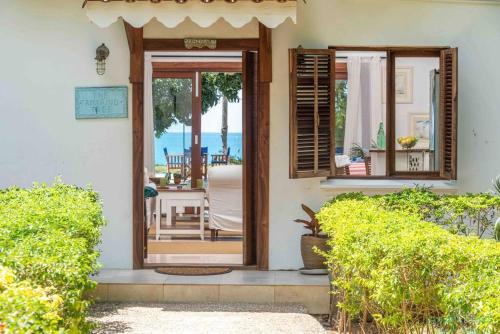 a front door of a house with a view of the ocean at Tamarind Tree Zanzibar in Mazizini