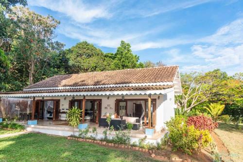 a small white house with a grass yard at Tamarind Tree Zanzibar in Mazizini