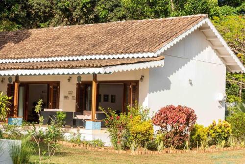 a small white house with a brown roof at Tamarind Tree Zanzibar in Mazizini