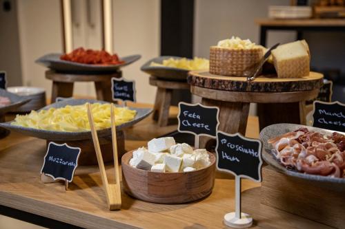 a buffet with different types of cheese and other foods at INNSiDE by Meliá Liverpool in Liverpool