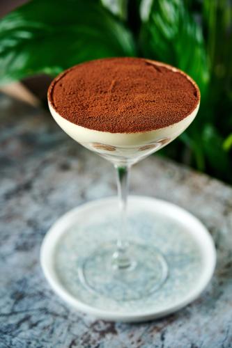 a drink on a white plate on a table at INNSiDE by Meliá Liverpool in Liverpool