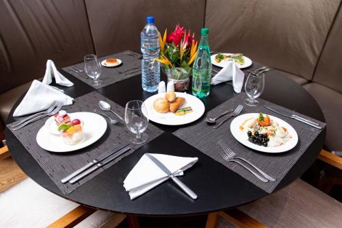 a black table with plates of food on it at Hotel 2 Fevrier, Lomé in Lomé