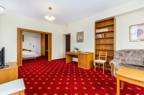 a living room with a couch and a bedroom at Willa Excelsior in Zakopane
