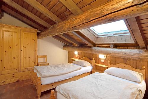 Posteľ alebo postele v izbe v ubytovaní Chalet Meridiana Appartamento 11