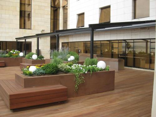 a building with a bunch of plants in front of it at Hotel Bahía in Santander